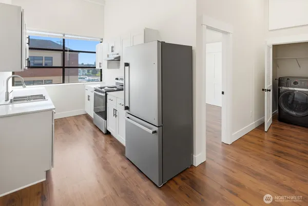 a kitchen with stainless steel appliances a refrigerator and a sink