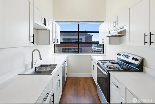 a kitchen with stainless steel appliances a stove sink and cabinets