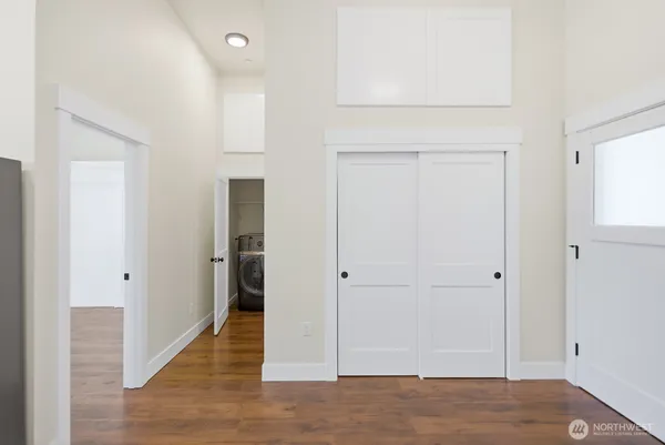 a view of an empty room with wooden floor
