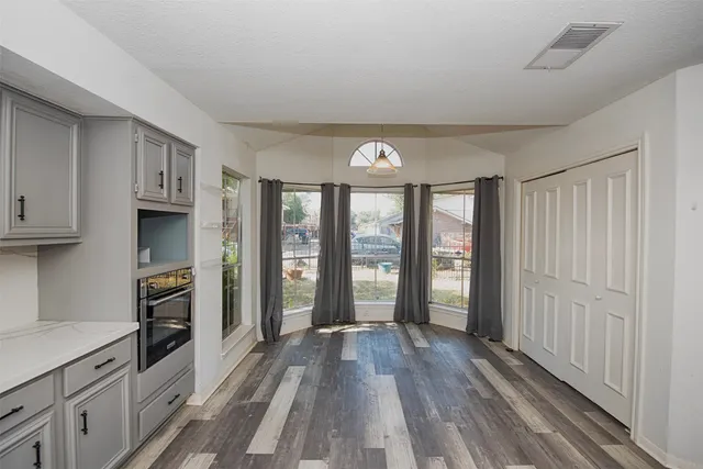a kitchen with a sink stove and cabinets