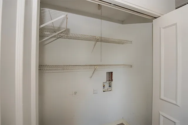 a large kitchen with a lot of cabinets and wooden floor