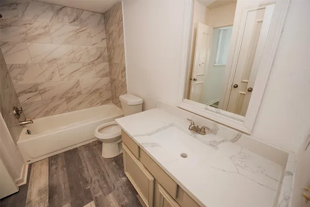 a bathroom with a sink a toilet and a bathtub