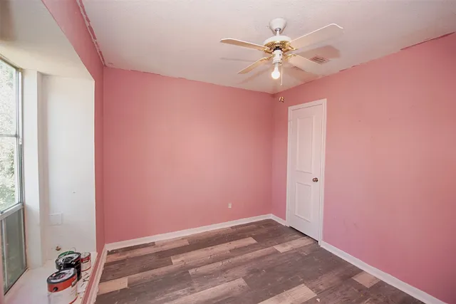 wooden floor in a room next to a window