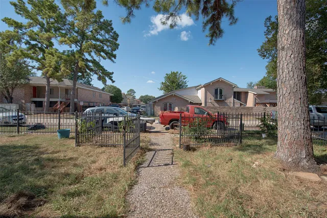 a backyard of a house with table and chairs