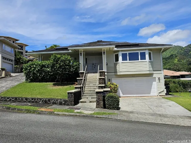 a front view of a house with a yard and garage