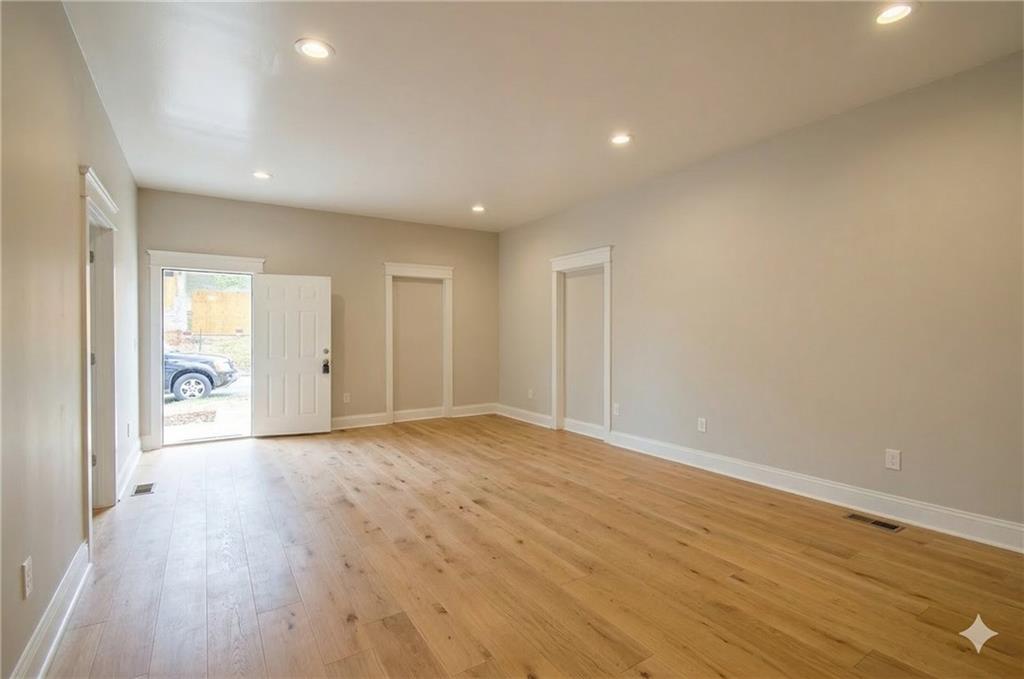 913 Smith Street Southwest Atlanta, GA 30310 - Photo 14 of 43 a view of an empty room with wooden floor and a window