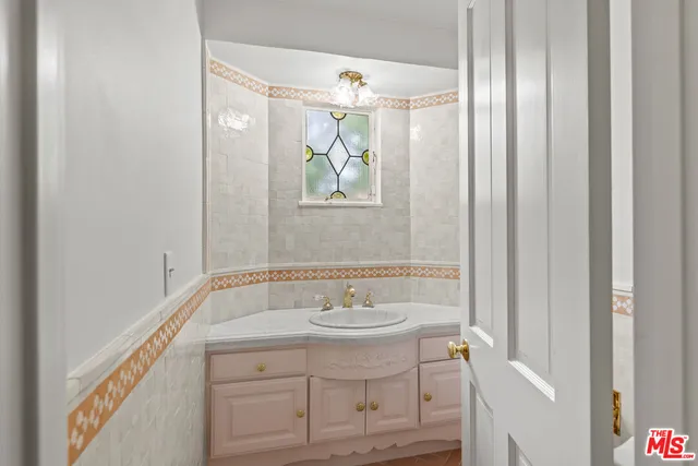 a bathroom with a sink a mirror and a window