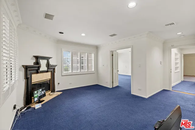 a view of empty room with furniture and fireplace