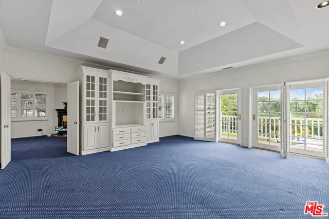 a view of an empty room with a balcony