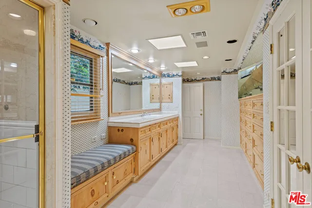 a bathroom with a double vanity sink and mirror