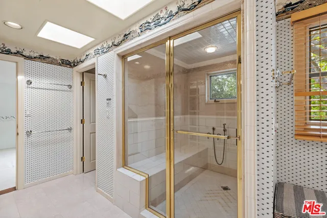 a bathroom with a shower and a sink