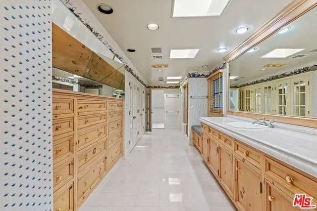 a hallway with wooden cabinets