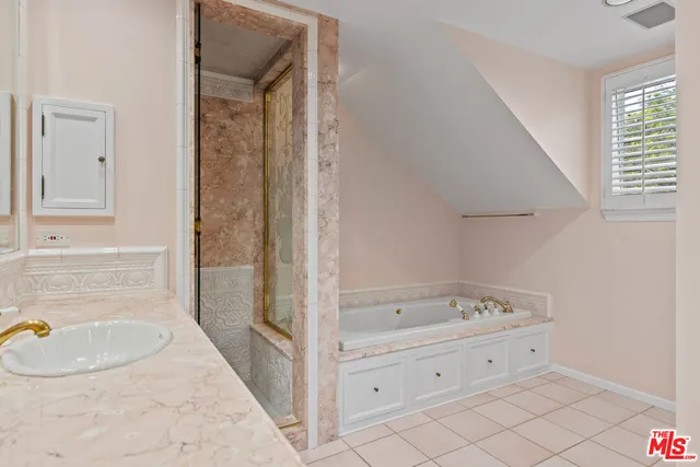 a bathroom with a tub sink and mirror
