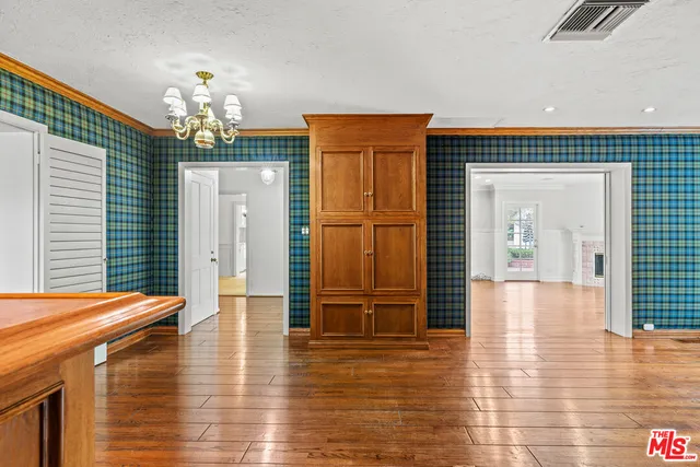 a view of a livingroom with furniture wooden floor and chandelier
