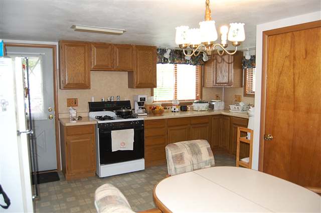 5763 West Richland Road Freeport, IL 61032 - Photo 2 of 9 a kitchen with a sink a stove a refrigerator and cabinets