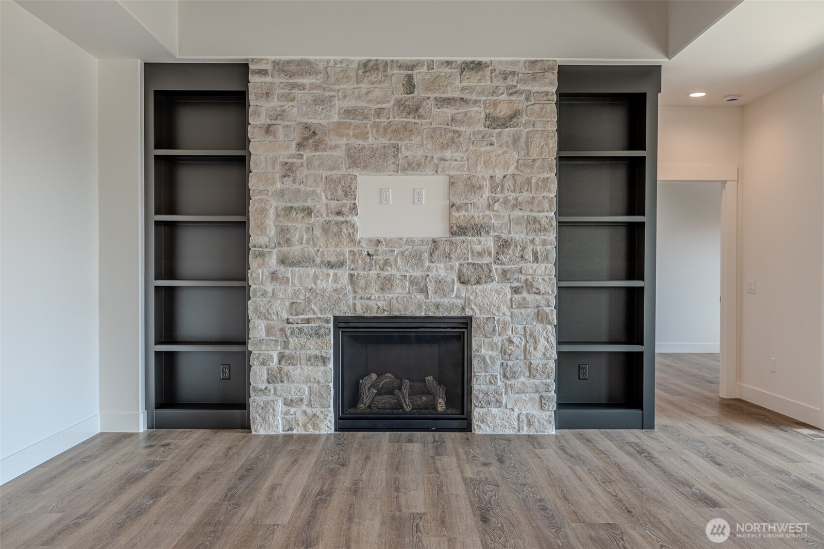 958 Racine Spgs Drive Wenatchee, WA 98801 - Photo 6 of 25 a living room with a fireplace and a book shelf