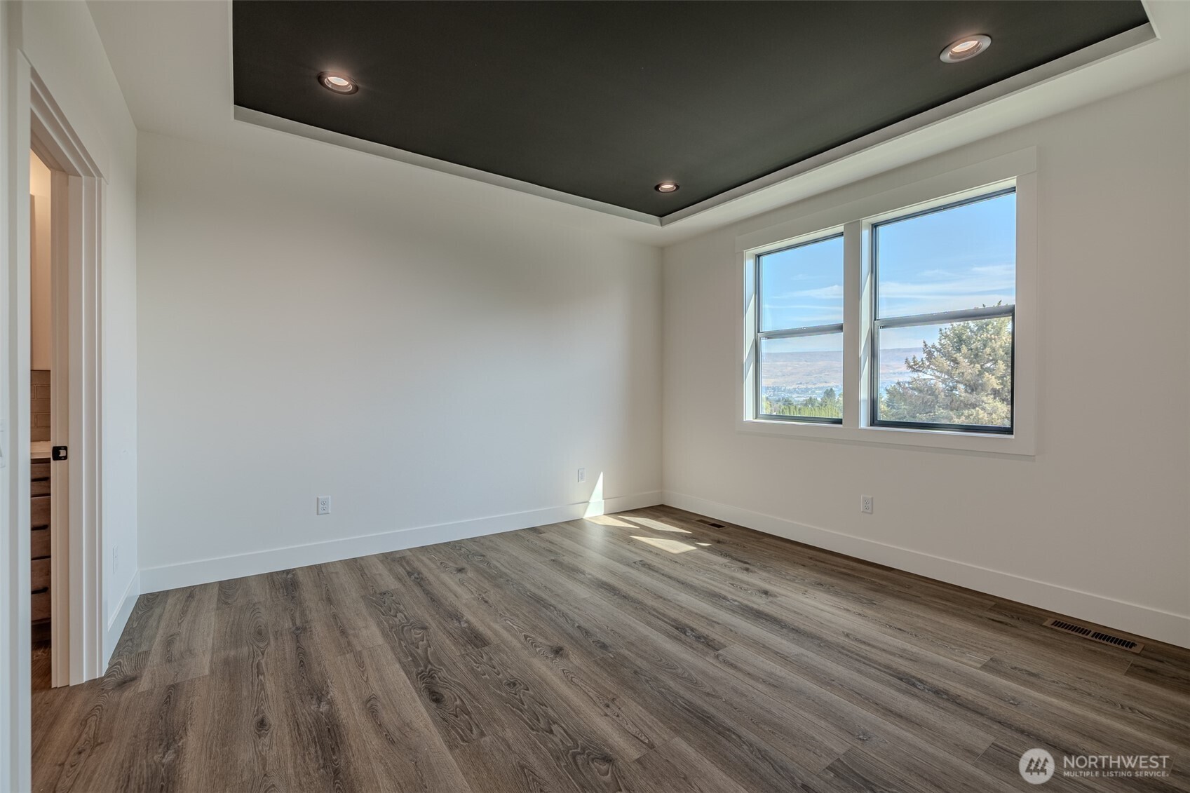 958 Racine Spgs Drive Wenatchee, WA 98801 - Photo 9 of 25 a view of an empty room with wooden floor and a window