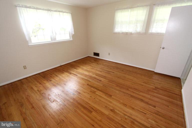 5218 Inverchapel Road Springfield, VA 22151 - Photo 22 of 30 an empty room with wooden floor and windows