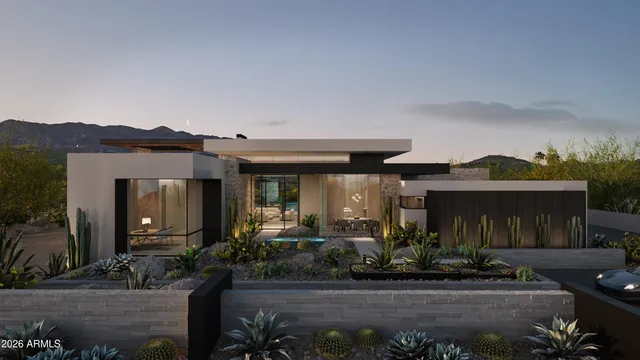 a front view of a house with plants