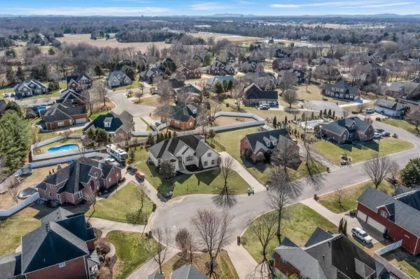 an aerial view of residential houses with outdoor space