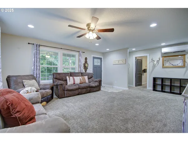 a living room with furniture and a chandelier