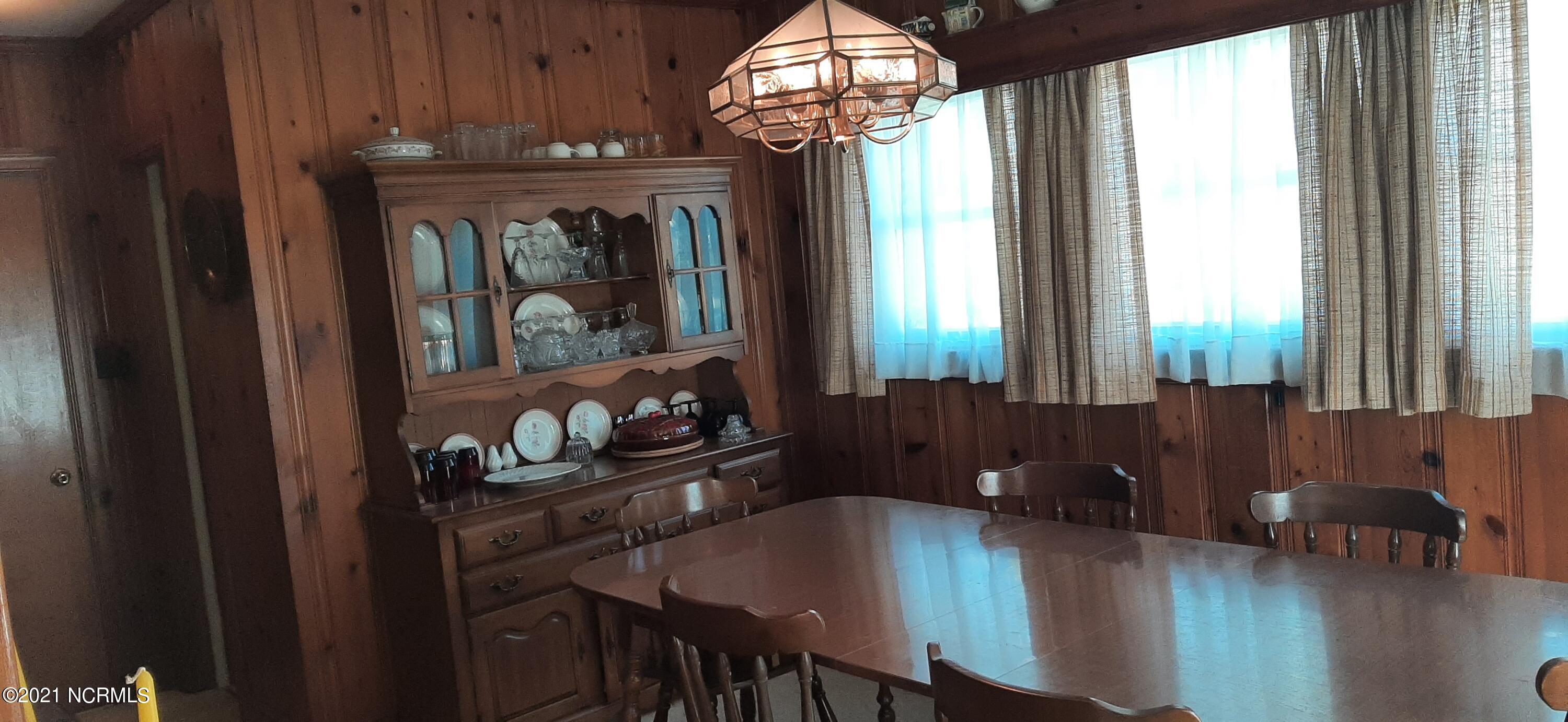 2310 Carey Road Kinston, NC 28504 - Photo 5 of 13 Formal dining with half-bath and door leading outside are on the far left.