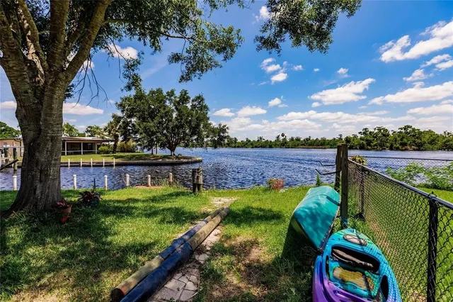 a view of a lake with houses in the back