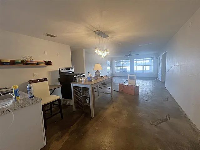 a view of a livingroom with furniture and a kitchen