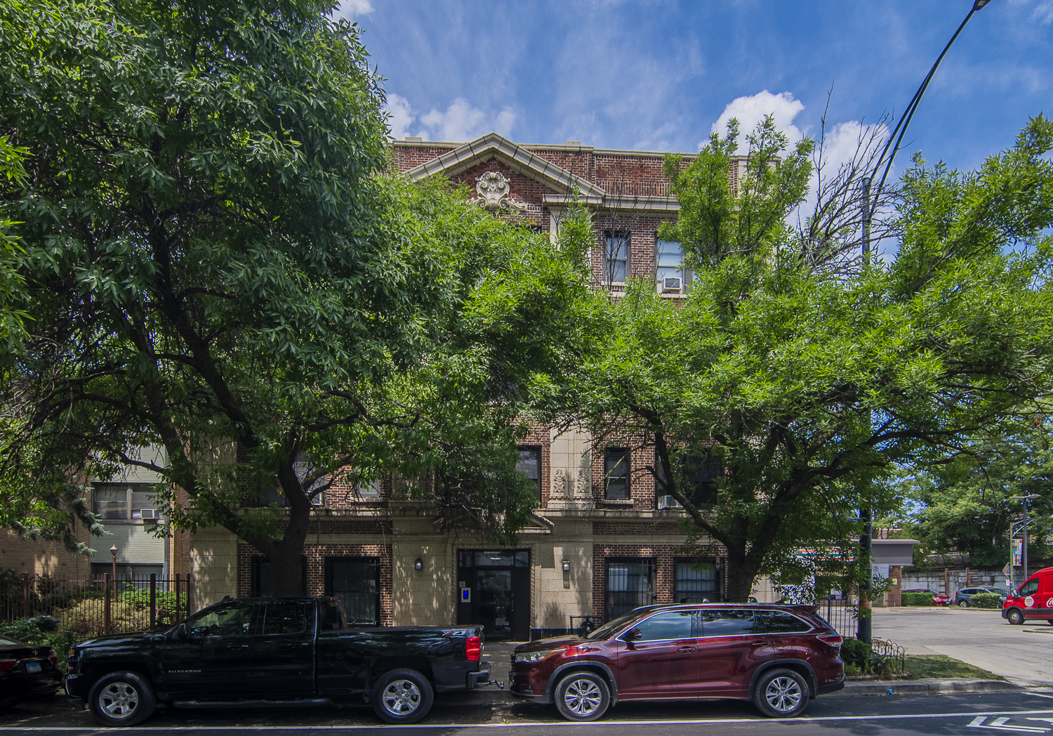 1414 West Pratt Boulevard, Unit 304 Chicago, IL 60626 - Photo 1 of 7 a front view of a building with trees