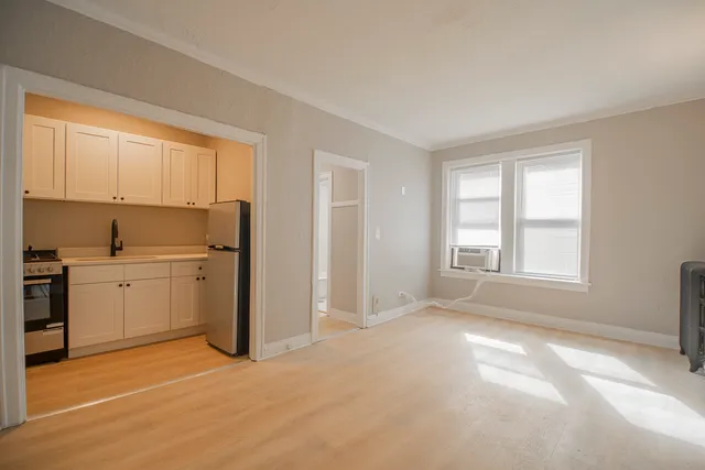 a view of a kitchen with wooden floor and electronic appliances