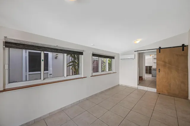 a view of an empty room with glass door