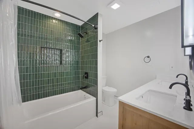 an empty room with windows and ceiling fan