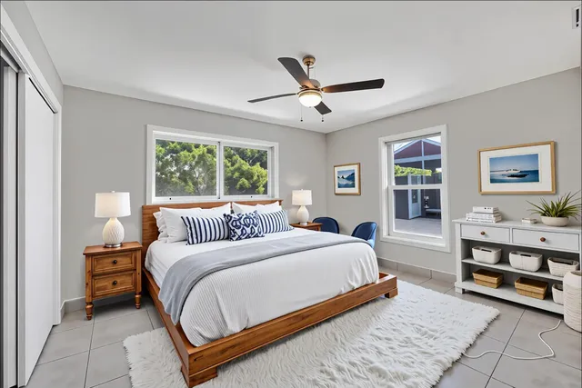 a spacious bedroom with a bed and a large window