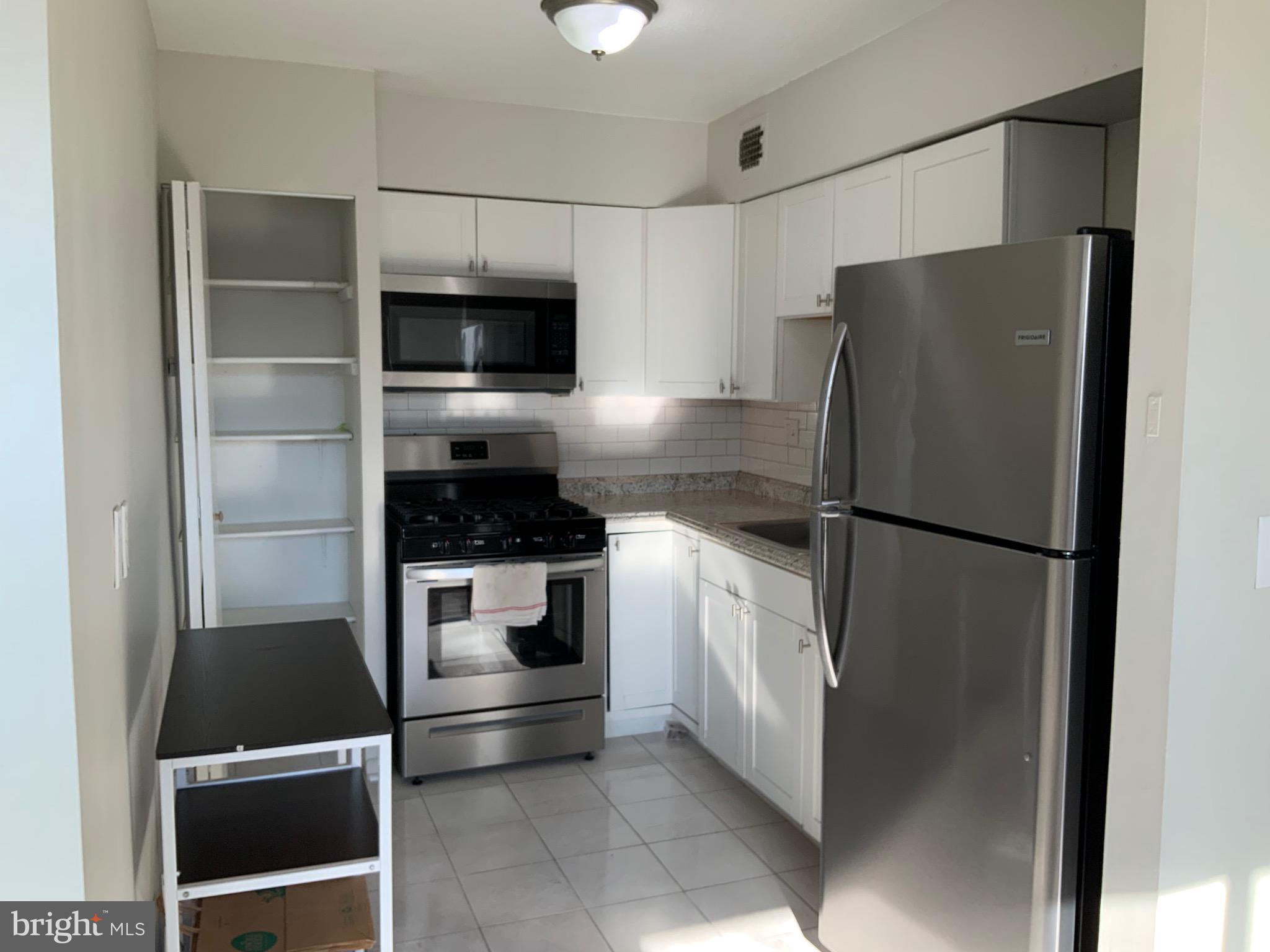 4410 Oglethorpe Street, Unit 201 Hyattsville, MD 20781 - Photo 6 of 13 a kitchen with a refrigerator and a stove