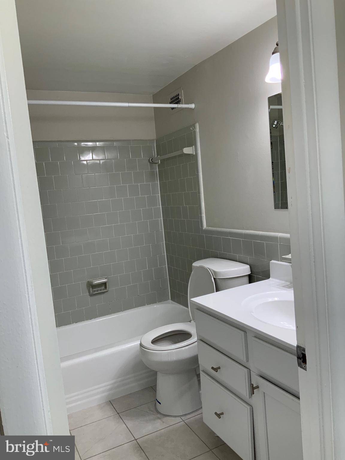 4410 Oglethorpe Street, Unit 201 Hyattsville, MD 20781 - Photo 8 of 13 a bathroom with a sink a toilet and shower