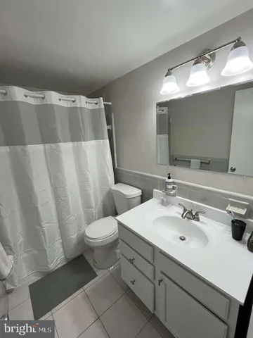 a bathroom with a sink toilet and mirror