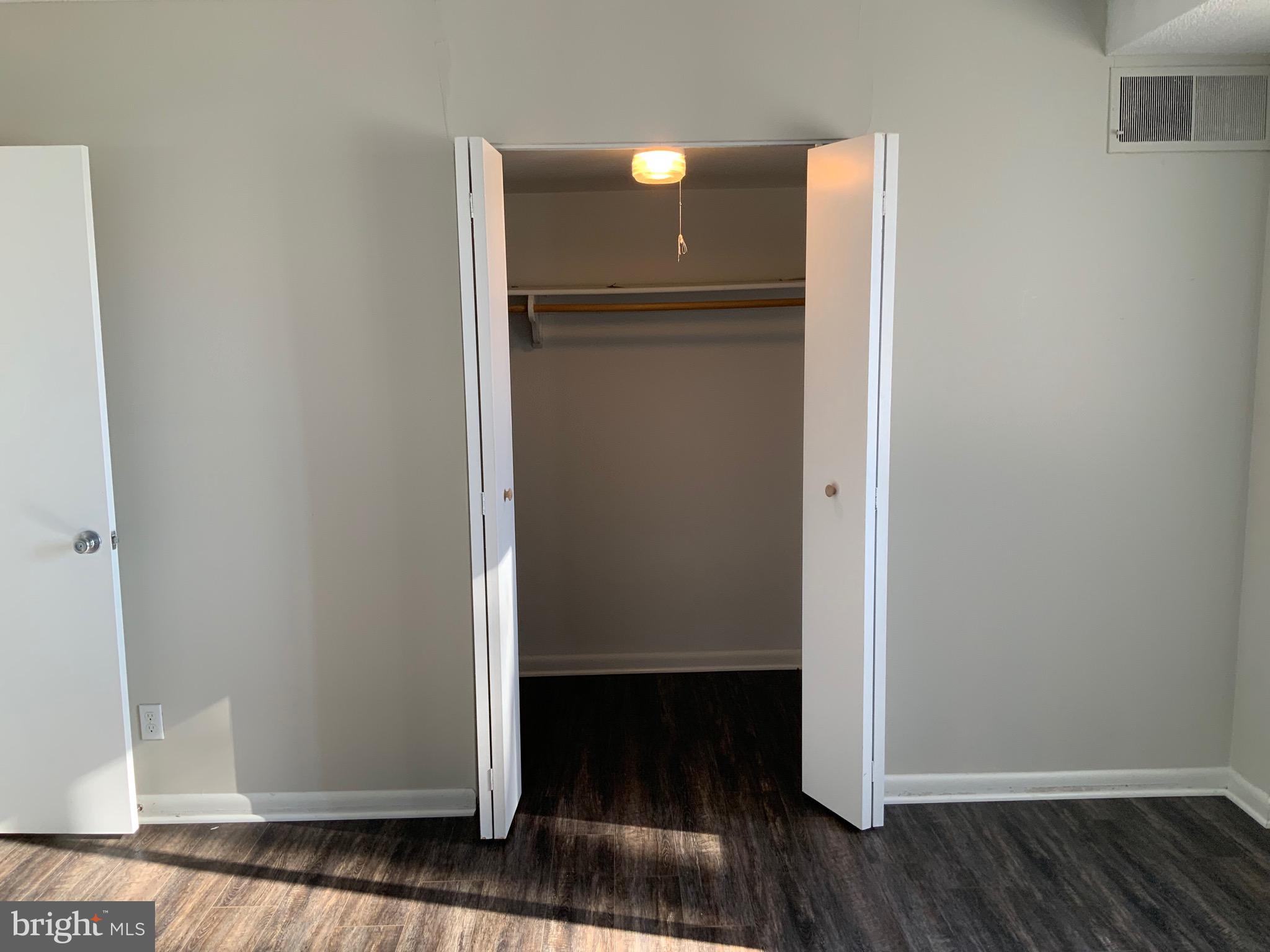 4410 Oglethorpe Street, Unit 201 Hyattsville, MD 20781 - Photo 10 of 13 a view of a livingroom with wooden floor and door