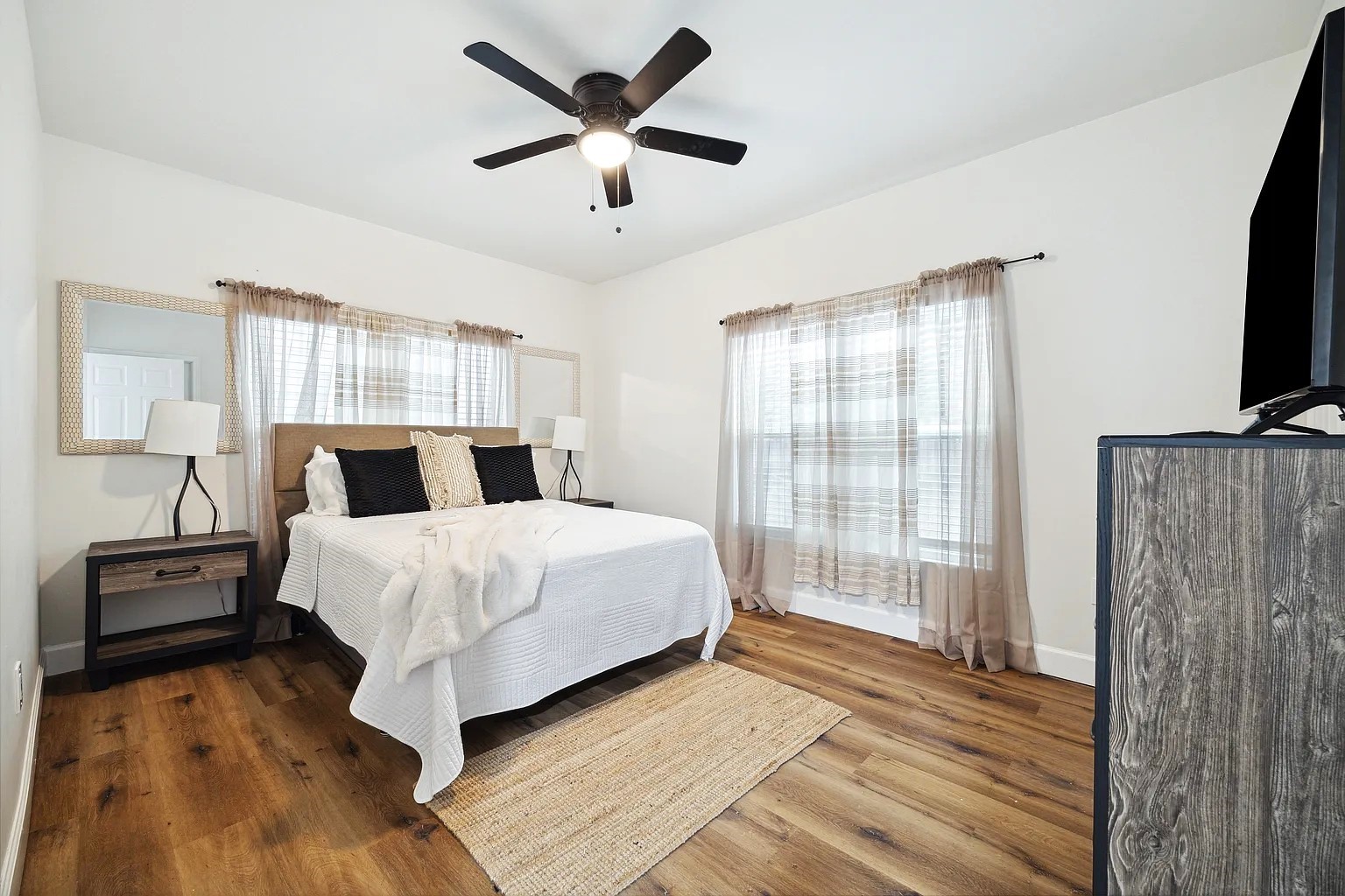2304 Chapman Street, Unit 3 Houston, TX 77009 - Photo 12 of 17 a bedroom with a large bed and a tv