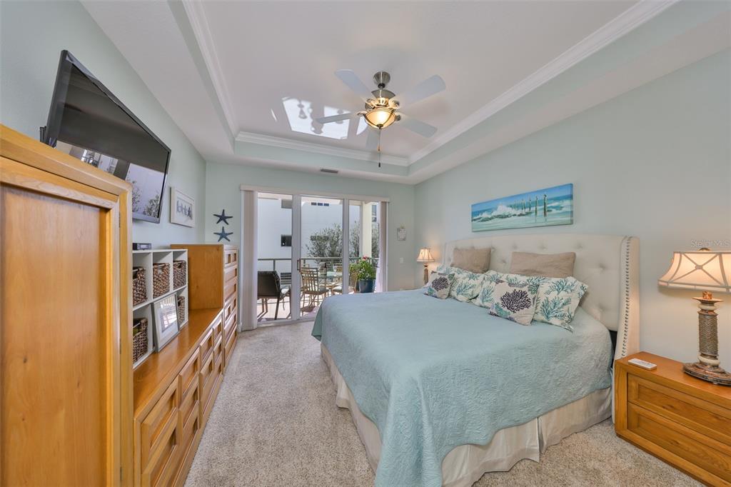 1030 Bellasol Way, Unit 302 Apollo Beach, FL 33572 - Photo 17 of 39 a bedroom with a bed and a chandelier