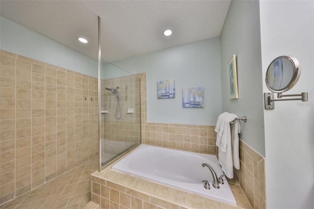 1030 Bellasol Way, Unit 302 Apollo Beach, FL 33572 - Photo 19 of 39 a bathroom with a tub a sink and a shower