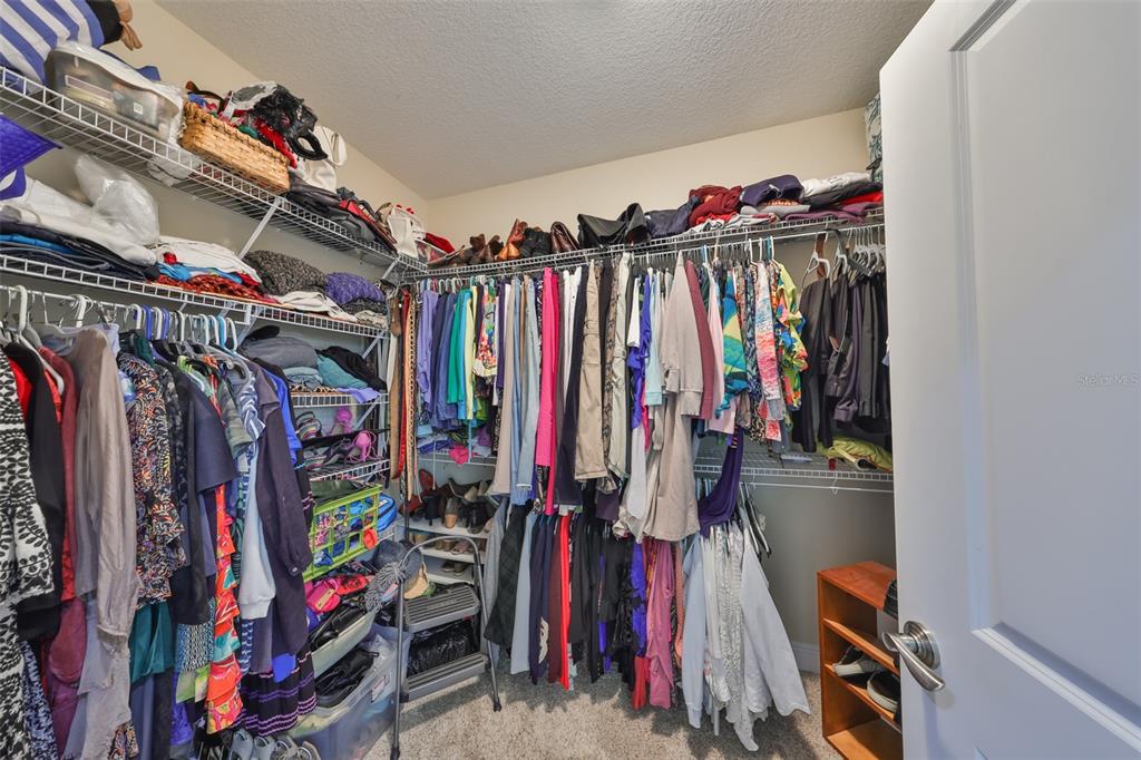 1030 Bellasol Way, Unit 302 Apollo Beach, FL 33572 - Photo 20 of 39 a view of walk in closet with clothes