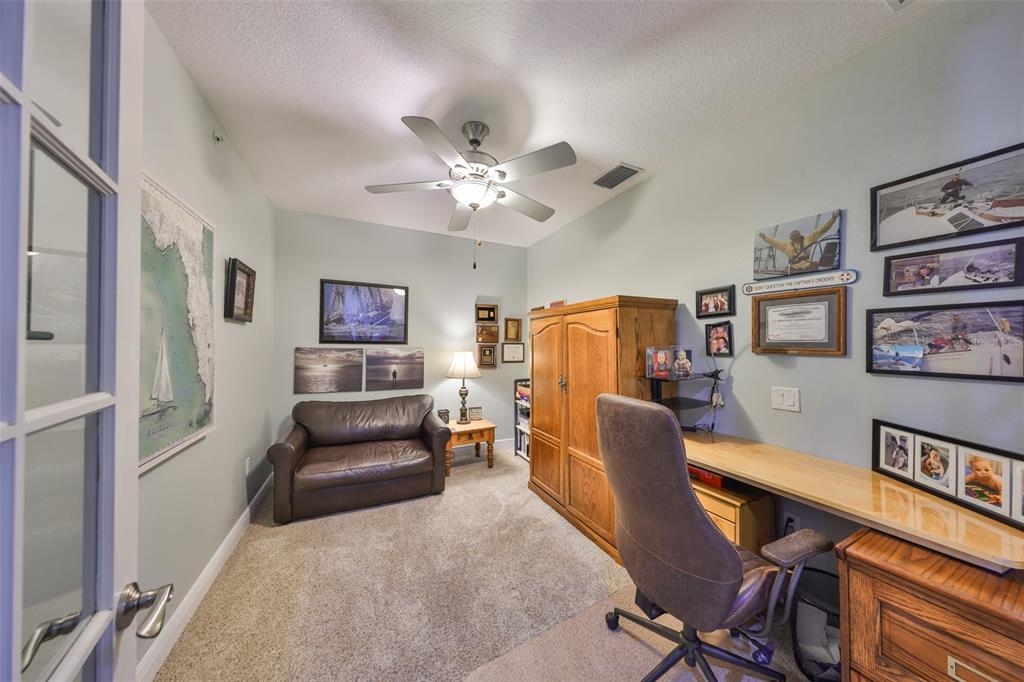 1030 Bellasol Way, Unit 302 Apollo Beach, FL 33572 - Photo 21 of 39 a living room with furniture and a chandelier