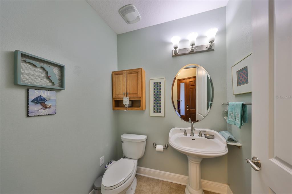 1030 Bellasol Way, Unit 302 Apollo Beach, FL 33572 - Photo 23 of 39 a bathroom with a toilet sink and mirror