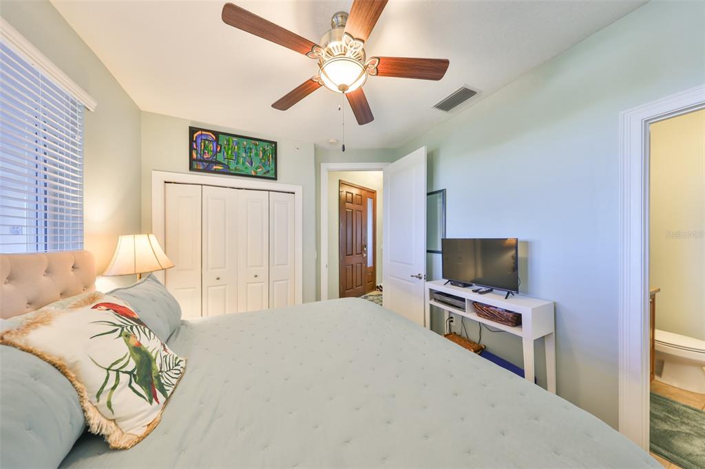1030 Bellasol Way, Unit 302 Apollo Beach, FL 33572 - Photo 25 of 39 a bedroom with a bed and a flat screen tv