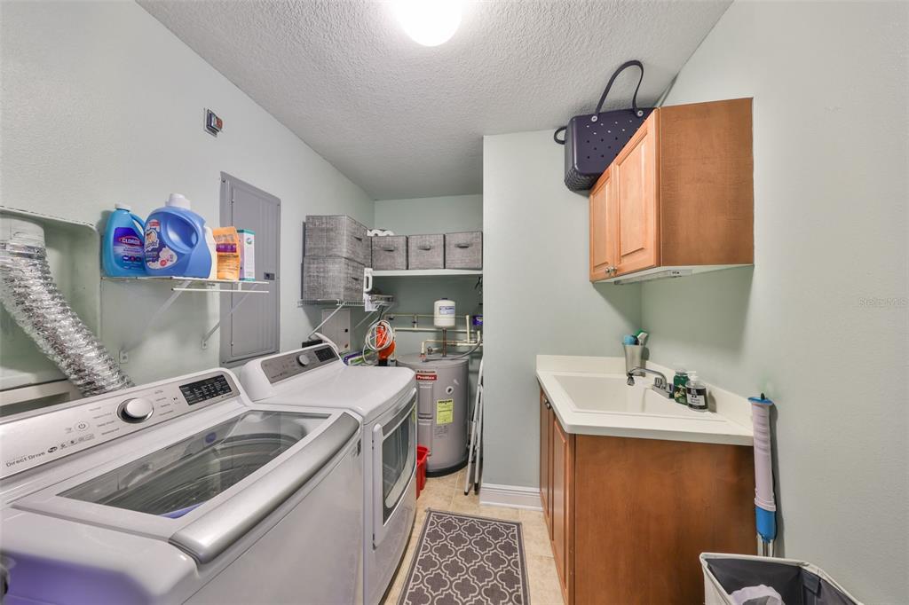 1030 Bellasol Way, Unit 302 Apollo Beach, FL 33572 - Photo 27 of 39 a room with a sink and a mirror