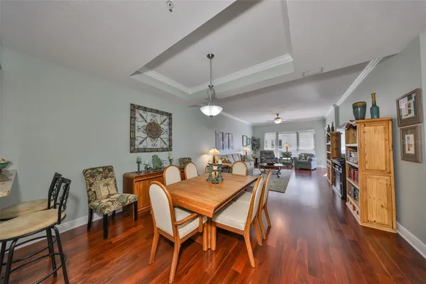 a dining room with furniture and wooden floor
