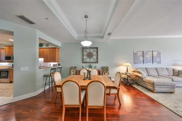 a view of a dining room with furniture wooden floor and chandelier