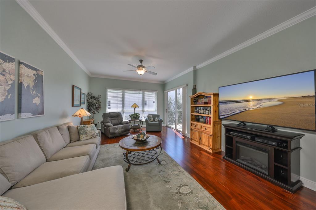 1030 Bellasol Way, Unit 302 Apollo Beach, FL 33572 - Photo 6 of 39 a living room with furniture and a flat screen tv