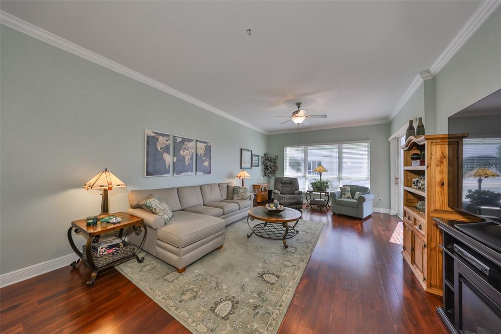 1030 Bellasol Way, Unit 302 Apollo Beach, FL 33572 - Photo 7 of 39 a living room with furniture and a flat screen tv