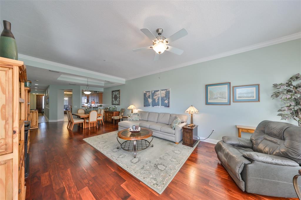 1030 Bellasol Way, Unit 302 Apollo Beach, FL 33572 - Photo 9 of 39 a living room with furniture and wooden floor